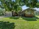 Charming single-Gathering home featuring well-maintained landscaping, a two-car garage, and brick accents at 1391 Terry Ln, Kissimmee, FL 34744