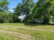 Spacious lot with mature trees, an RV, and the potential to build your dream home or enjoy the space as is at 1391 Terry Ln, Kissimmee, FL 34744