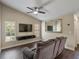 Comfortable living room with tile floors, ceiling fan, and mounted television at 1391 Terry Ln, Kissimmee, FL 34744