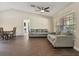 Spacious living room featuring tiled floors, comfortable seating, and easy access to the dining area, perfect for entertaining at 1391 Terry Ln, Kissimmee, FL 34744