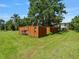 Large outbuilding in a grassy backyard setting with trees at 1391 Terry Ln, Kissimmee, FL 34744