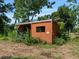 Small enclosed wooden outbuilding surrounded by greenery at 1391 Terry Ln, Kissimmee, FL 34744