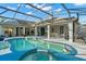 Screened-in lanai with a pool, backyard, and grill; great for entertaining at 14131 Islamorada Dr, Orlando, FL 32837