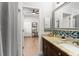 Nicely appointed bathroom with granite vanity, tile accents, and a view into the adjacent bedroom at 14131 Islamorada Dr, Orlando, FL 32837