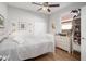 Cozy bedroom with wood floors, ceiling fan, and window bringing in natural light at 14131 Islamorada Dr, Orlando, FL 32837