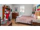 A stylish bedroom features a racing-style chair, decorative posters, and comfortable furnishings at 14131 Islamorada Dr, Orlando, FL 32837