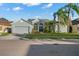 Charming single Gathering home with a manicured front yard, lush landscaping, and gray exterior at 14131 Islamorada Dr, Orlando, FL 32837