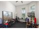 This home gym features an exercise bike, free weights, and multiple windows providing natural light at 14131 Islamorada Dr, Orlando, FL 32837