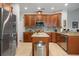 Kitchen features dark wood cabinetry, stainless steel appliances, granite countertops and tile backsplash at 14131 Islamorada Dr, Orlando, FL 32837