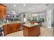 Open concept kitchen with granite countertops, stainless steel appliances, and view of the dining area at 14131 Islamorada Dr, Orlando, FL 32837