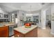 Kitchen with a center island, granite countertops, stainless steel appliances, and an adjacent dining area at 14131 Islamorada Dr, Orlando, FL 32837