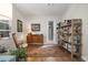 Cozy living room with vintage dresser, colorful rug, and natural light streaming in from the window at 14131 Islamorada Dr, Orlando, FL 32837