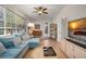Spacious living area featuring a large sectional, stylish furnishings, and natural light, great for relaxing at 14131 Islamorada Dr, Orlando, FL 32837