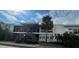 Condo building with screen porches, stairs and mature landscaping under blue skies at 151 N Orlando Ave # 118, Winter Park, FL 32789