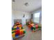 Bright bedroom with two twin beds, colorful decor, and a window offering plenty of natural light at 16391 Admirals Cove Ln, Winter Garden, FL 34787