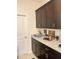 A stylish countertop with dark wood cabinetry, providing generous storage and displaying a cozy decorative corner at 16391 Admirals Cove Ln, Winter Garden, FL 34787