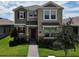 Charming two-story home with a mix of neutral siding, stone accents, manicured lawn, and an inviting front entrance at 16391 Admirals Cove Ln, Winter Garden, FL 34787
