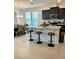 Contemporary kitchen featuring a center island with bar stool seating, black cabinets, and stainless appliances with natural light at 16391 Admirals Cove Ln, Winter Garden, FL 34787