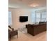 Open living room features neutral tile, a large flat screen television, multiple windows, and modern furnishings at 16391 Admirals Cove Ln, Winter Garden, FL 34787