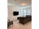 Open living room features neutral tile, a large flat screen television, multiple windows, and modern furnishings at 16391 Admirals Cove Ln, Winter Garden, FL 34787