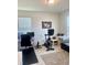 Office space offers a desk area, work out bicycle, neutral walls, and light colored wood flooring with lots of natural light at 16391 Admirals Cove Ln, Winter Garden, FL 34787