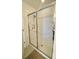Modern shower with sliding glass doors, a built-in niche, and sleek hardware for a spa-like experience at 16391 Admirals Cove Ln, Winter Garden, FL 34787