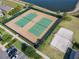 Aerial view of community tennis and sand volleyball courts by lake at 16391 Admirals Cove Ln, Winter Garden, FL 34787