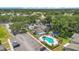 Aerial view showing a community pool surrounded by lush greenery at 1642 Windsor Oak Ct, Kissimmee, FL 34744