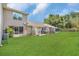 Large grassy backyard with the rear of the house in the background at 1642 Windsor Oak Ct, Kissimmee, FL 34744