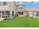 A view of a spacious backyard with lawn at 1642 Windsor Oak Ct, Kissimmee, FL 34744
