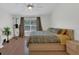Comfortable bedroom with wood floors, ceiling fan, and large window at 1642 Windsor Oak Ct, Kissimmee, FL 34744