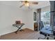 Bright bedroom with natural light, a ceiling fan, and space for a desk or study area at 1642 Windsor Oak Ct, Kissimmee, FL 34744