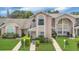 Charming townhome with manicured lawn and inviting facade with unique architectural detail at 1642 Windsor Oak Ct, Kissimmee, FL 34744