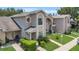 Charming two-story townhouse with manicured lawn and walkway at 1642 Windsor Oak Ct, Kissimmee, FL 34744