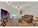 Cozy living room featuring a large television, plush sofa, and sliding glass doors to the outside at 1642 Windsor Oak Ct, Kissimmee, FL 34744