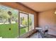 Enclosed patio overlooking landscaped backyard with table and chairs at 1642 Windsor Oak Ct, Kissimmee, FL 34744