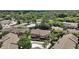 Beautiful aerial view of community featuring a neighborhood pool and surrounding trees at 184 Sandlewood Trl # 2, Winter Park, FL 32789