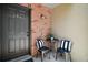 Inviting entryway with a black front door, brick accent wall, and cozy seating area at 184 Sandlewood Trl # 2, Winter Park, FL 32789