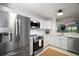 Modern kitchen featuring stainless steel appliances, white cabinets, and subway tile backsplash at 184 Sandlewood Trl # 2, Winter Park, FL 32789