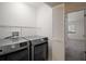 Modern laundry room featuring updated washer and dryer with access to bedroom at 184 Sandlewood Trl # 2, Winter Park, FL 32789
