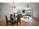 Open concept living room and dining area featuring hardwood floors and natural light at 184 Sandlewood Trl # 2, Winter Park, FL 32789