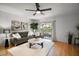 Bright living room with hardwood floors, stylish furnishings, and a sliding glass door to the patio at 184 Sandlewood Trl # 2, Winter Park, FL 32789