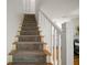 Carpeted staircase with white railing leading to the upper level of the home at 184 Sandlewood Trl # 2, Winter Park, FL 32789