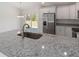 Granite countertops add a touch of elegance to this bright and modern kitchen at 1900 Sw 178Th Street Rd, Ocala, FL 34473