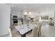 A dining area adjacent to a modern kitchen, complete with stylish furnishings and abundant natural light at 1900 Sw 178Th Street Rd, Ocala, FL 34473