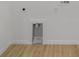 Simple laundry room features wood floors and a wall with an alcove for appliances at 1900 Sw 178Th Street Rd, Ocala, FL 34473