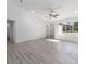 Bright living room with a ceiling fan, fresh paint, and new flooring creating an inviting atmosphere at 1900 Sw 178Th Street Rd, Ocala, FL 34473