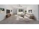 Bright living room with white walls, modern furnishings, neutral rug, and a large window with wooded views at 1900 Sw 178Th Street Rd, Ocala, FL 34473