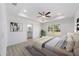 Serene main bedroom with tray ceiling, ensuite bathroom, and large windows offering ample natural light at 1900 Sw 178Th Street Rd, Ocala, FL 34473