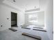 Unfinished main bedroom featuring wood flooring, recessed lighting, a tray ceiling, and an ensuite bathroom at 1900 Sw 178Th Street Rd, Ocala, FL 34473